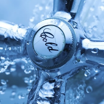 A cold water tap with shivering droplets, photographed in a cool tone.
